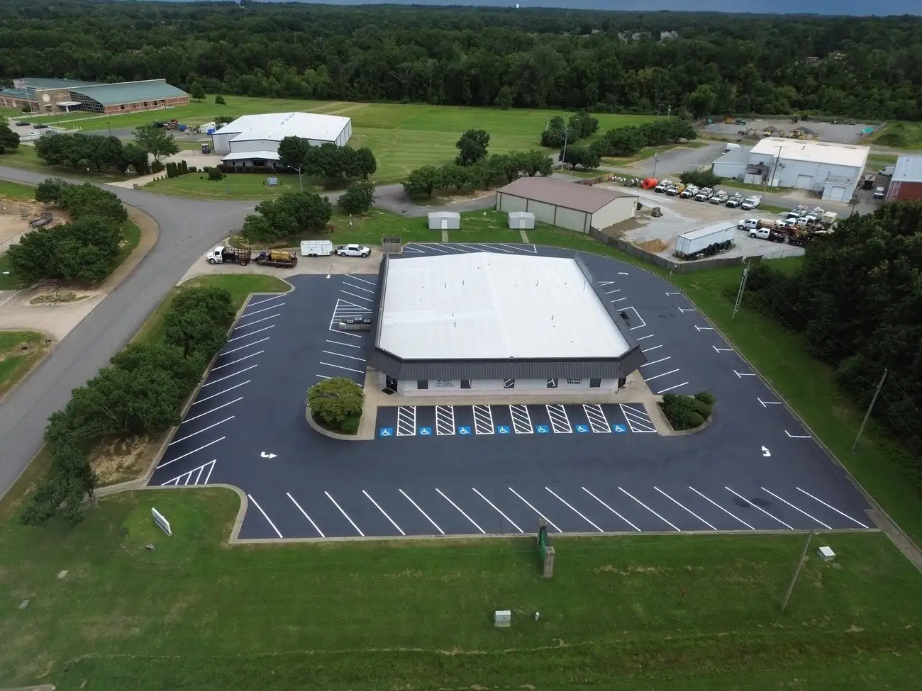 Aerial view of a large commercial parking lot with landscaped tree islands, striped by the Arkansas Pavement crew
