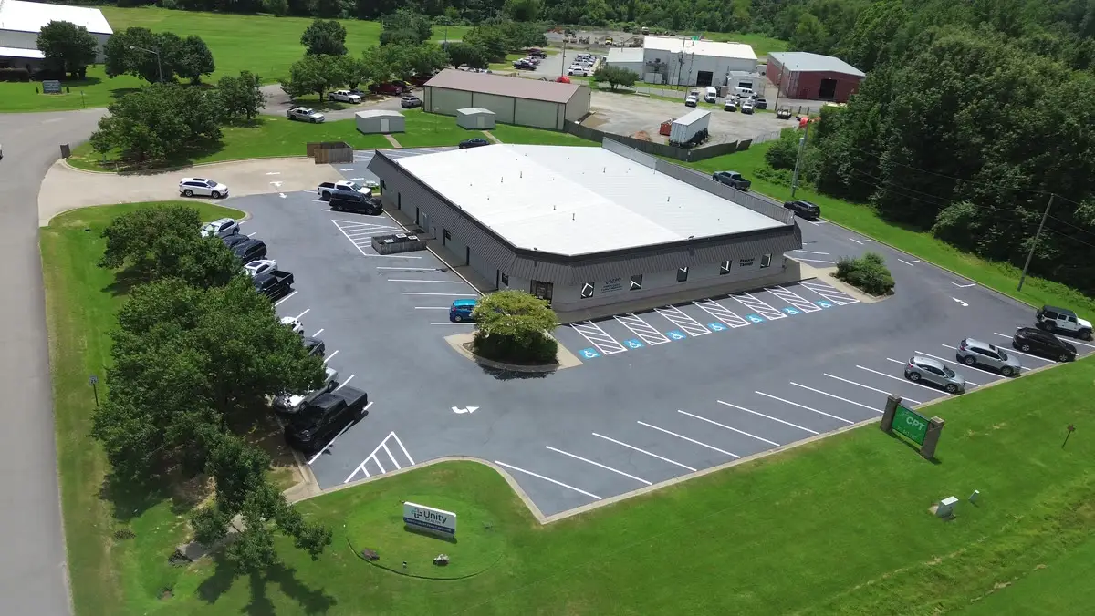 Aerial view of a finished commercial lot, freshly striped with accessible stalls along the building frontage