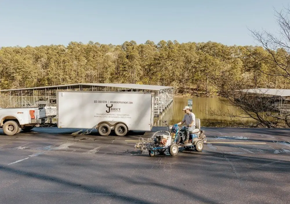 The striping trailer and ride on striper set up beside the water