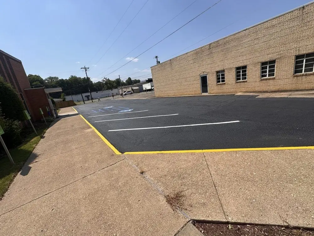 A new white directional arrow painted on a resurfaced lot