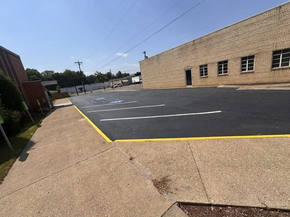 A new white directional arrow painted on a resurfaced lot