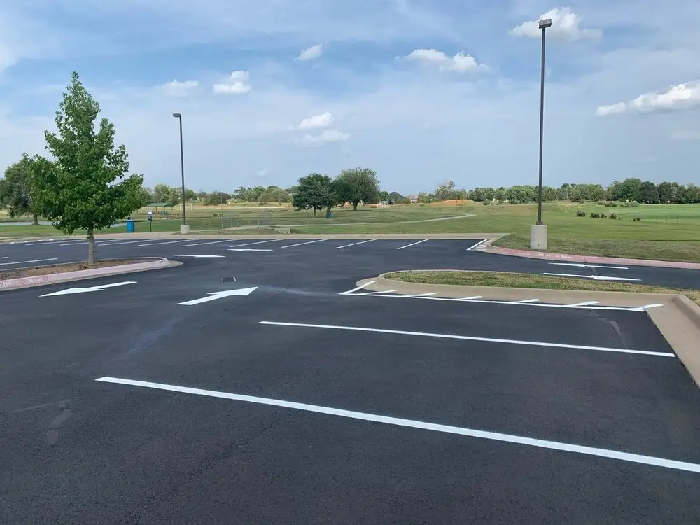 Crisp white lines and a curb on newly finished asphalt