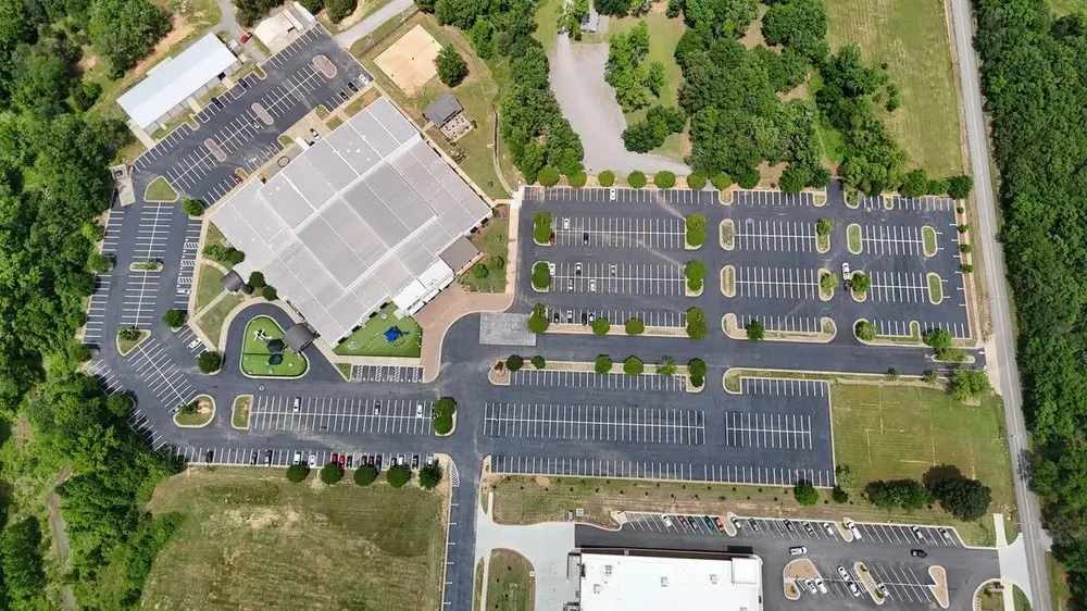 Aerial view of a large campus lot with landscaped islands and long stall runs